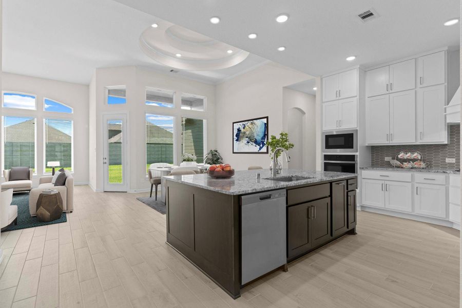 Gorgeous gourmet kitchen with oversized island, modern pendant lighting, and a seamless connection to the dining and family room for effortless entertaining. *Virtually Staged*