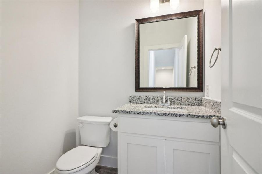 Bathroom featuring vanity and toilet