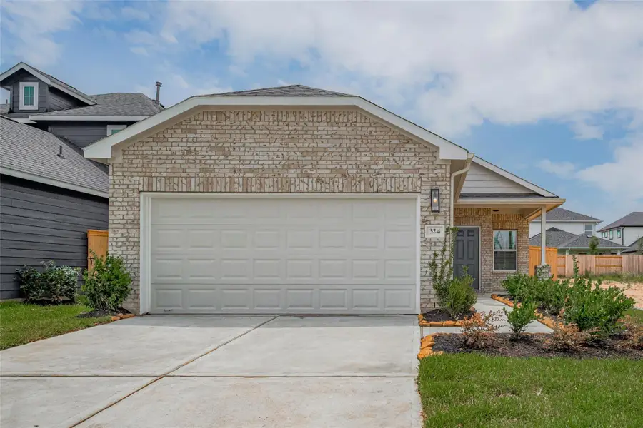Front exterior of a new home in La Segarra, Brookshire, TX, highlighting curb appeal (Image 2). Front exterior of a new home in La Segarra, Brookshire, TX, highlighting curb appeal (Image 2).