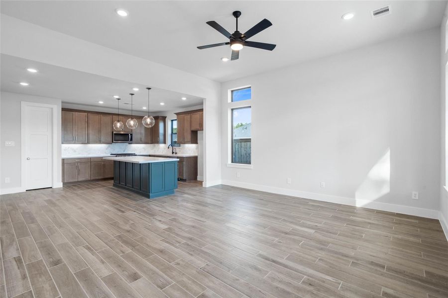 The intentional open design fosters a deep sense of connection between all three primary living zones. Sightlines remain clear from the island to the sofa, promoting inclusive living and effortless entertaining. The intentional open design fosters a deep sense of connection between all three primary living zones. Sightlines remain clear from the island to the sofa, promoting inclusive living and effortless entertaining.