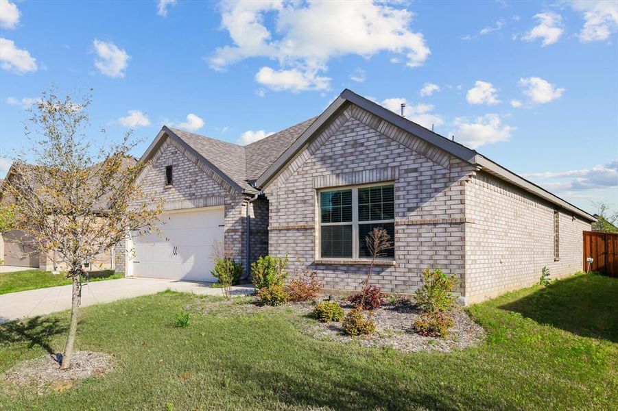 View of front of home with brick siding, driveway, a garage, and a front lawn View of front of home with brick siding, driveway, a garage, and a front lawn