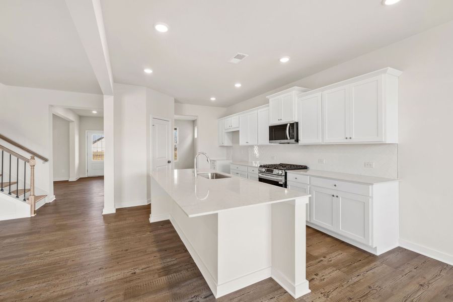 A kitchen with white cabinets.