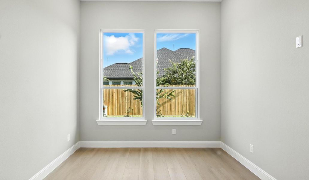 This sunlit room features large windows that bring in plenty of natural light and offer relaxing backyard views. The neutral wall tones and light wood flooring create an airy, modern atmosphere that complements any style. Perfect as a guest bedroom, playroom, or home office, this space offers flexibility to meet your lifestyle needs while maintaining the home’s elegant design continuity. This sunlit room features large windows that bring in plenty of natural light and offer relaxing backyard views. The neutral wall tones and light wood flooring create an airy, modern atmosphere that complements any style. Perfect as a guest bedroom, playroom, or home office, this space offers flexibility to meet your lifestyle needs while maintaining the home’s elegant design continuity.