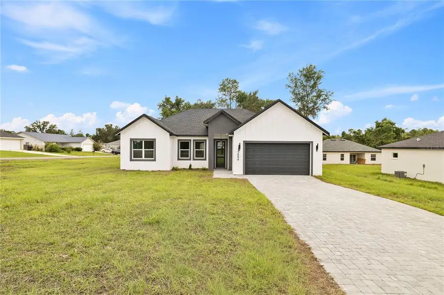 Front exterior of a new home in , Ocala, FL, highlighting curb appeal (Image 1). Front exterior of a new home in , Ocala, FL, highlighting curb appeal (Image 1).