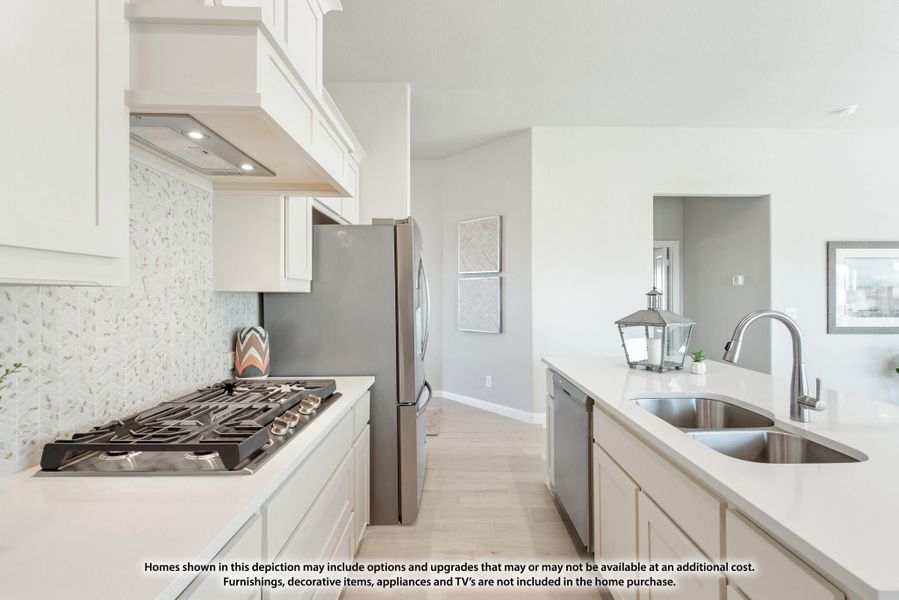 Kitchen with white cabinets, gas cooktop, stainless steel appliances, tile backsplash, and double sink on island Kitchen with white cabinets, gas cooktop, stainless steel appliances, tile backsplash, and double sink on island