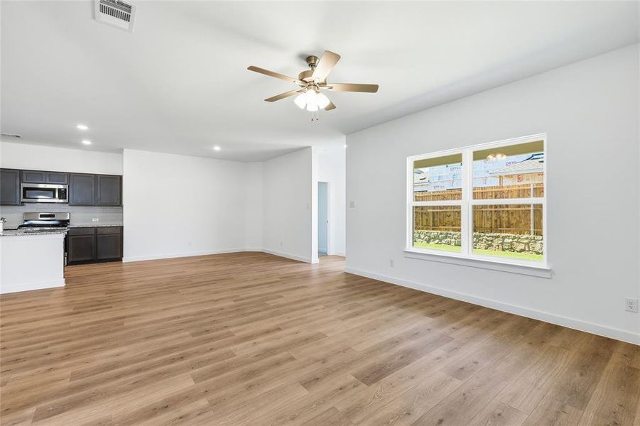 Unfurnished living room with a ceiling fan, light wood-style floors, and recessed lighting