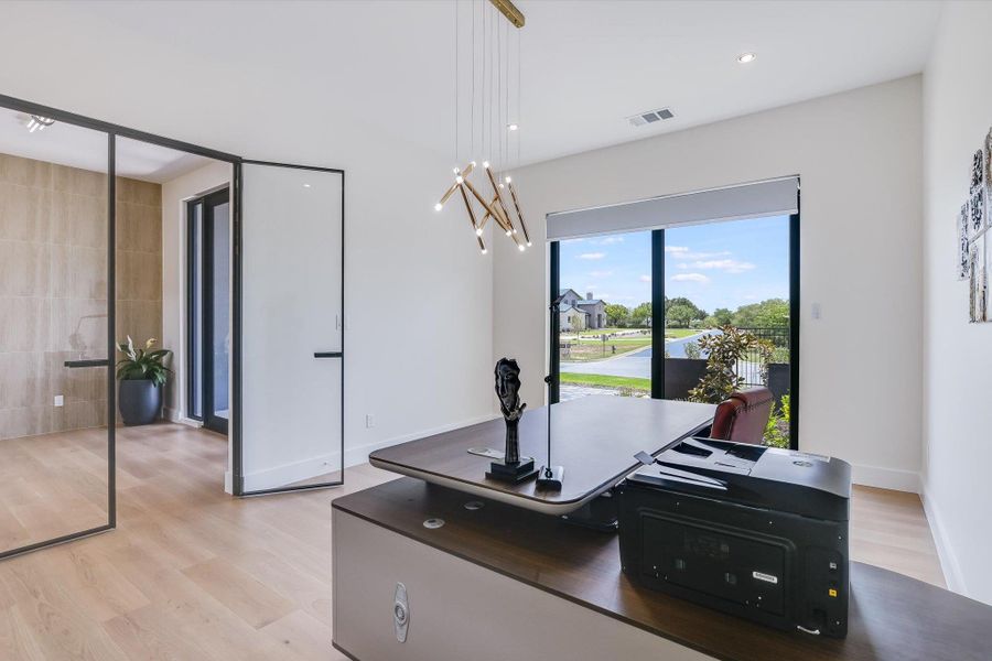 Study/ office or secondary living area with light wood flooring, a custom chandelier, and recessed lighting Study/ office or secondary living area with light wood flooring, a custom chandelier, and recessed lighting