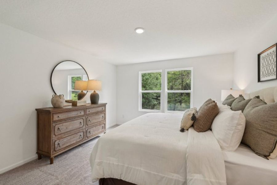 A bedroom with a bed and a dresser. A bedroom with a bed and a dresser.