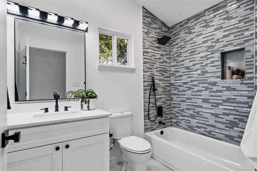 Full bath with tub / shower combination, vanity, and tile patterned flooring