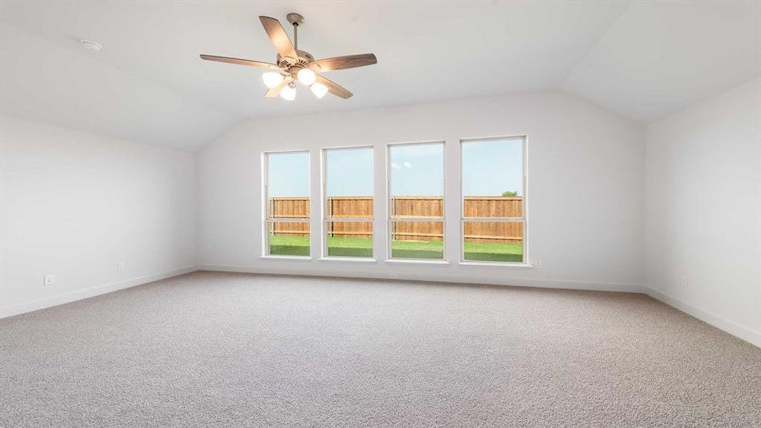 Bonus room featuring carpet, ceiling fan, and vaulted ceiling