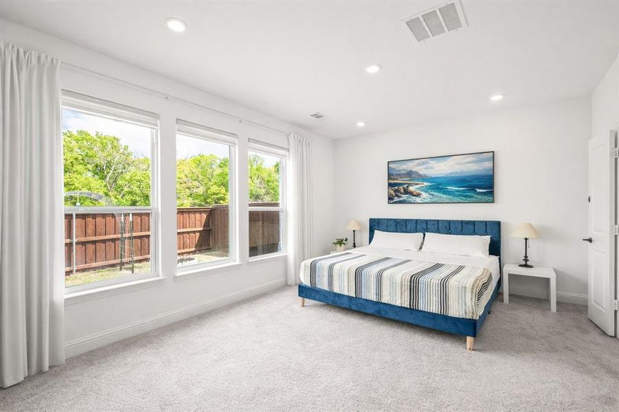 Bedroom with light colored carpet and recessed lighting