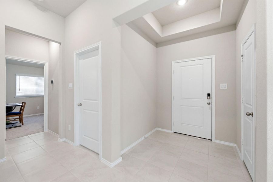 Front door and easy access to the laundry room and garage.  Don't miss the coat closet at the front.