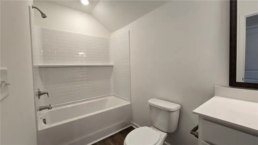 A classic tiled tub-and-shower combination anchors