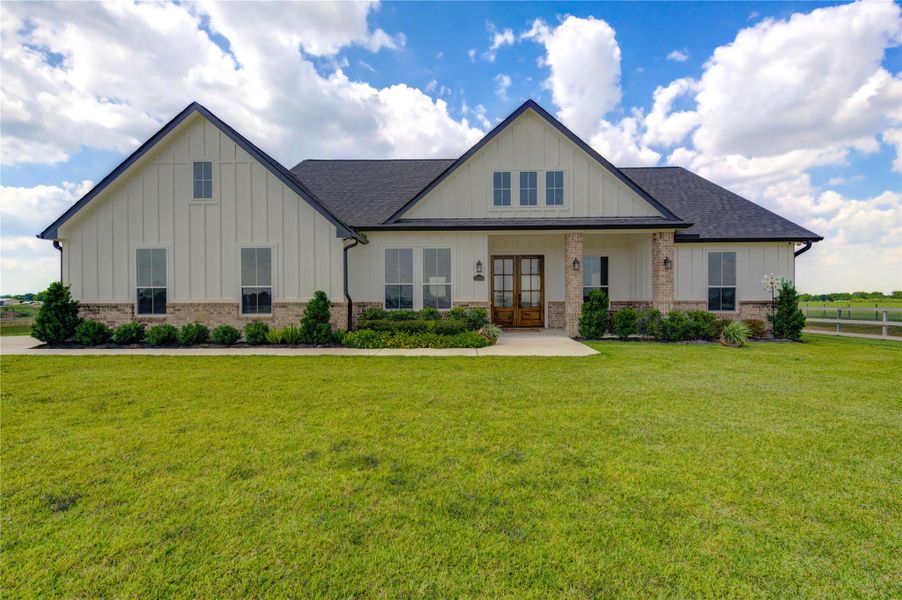 Modern farmhouse with inviting curb appeal on over an acre of land.