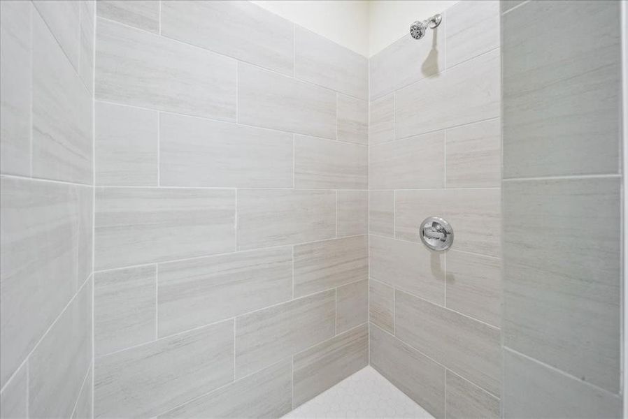 Bathroom featuring tiled shower