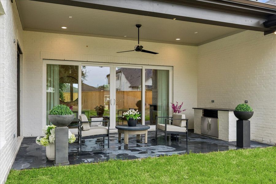 Covered outdoor living with built-in Coyote gas grill