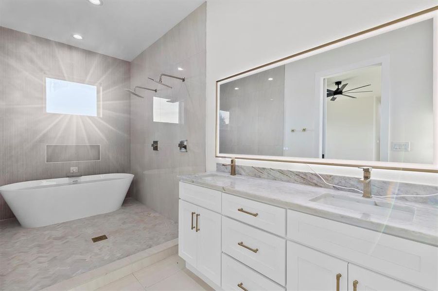 Large shower room with two shower heads, and a stand along tub! Beautiful double vanities in this primary suite.