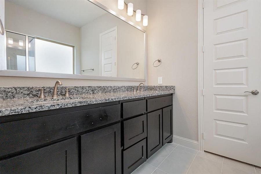 Bathroom with tile patterned floors and vanity