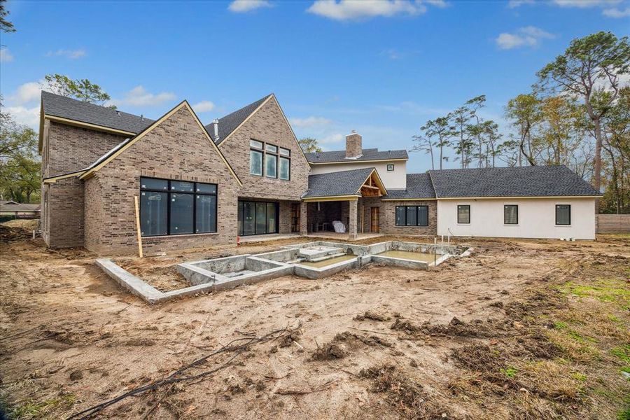 This view maximized the spacious yard and extra potential green space, the pool that will be complete with the home and the outdoor kitchen, covered pavilion and the casita.