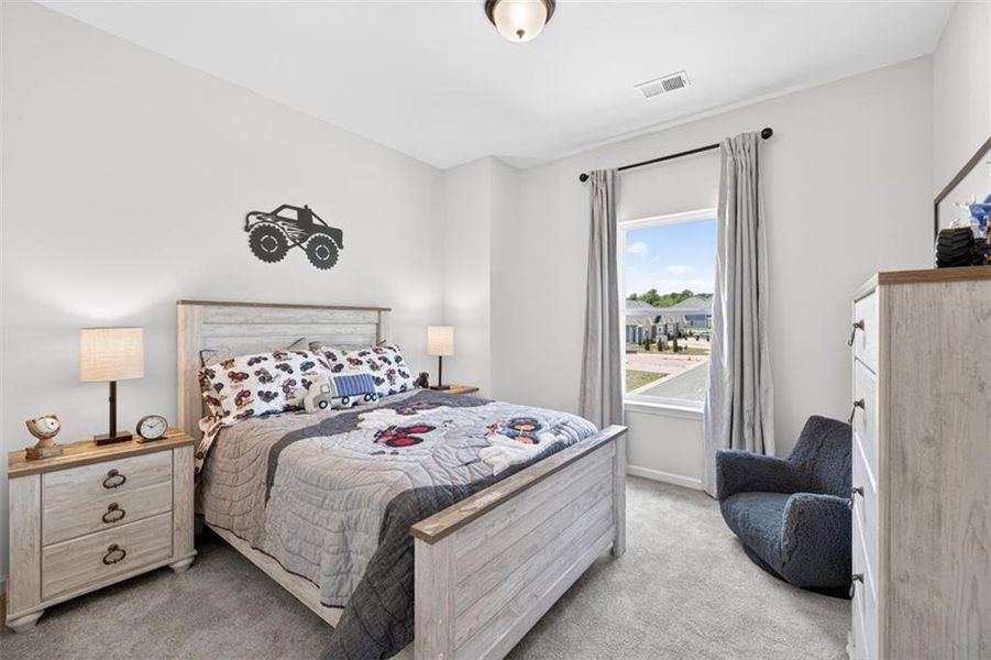 Carpeted bedroom with a single window, recessed lighting, and a neutral wall color