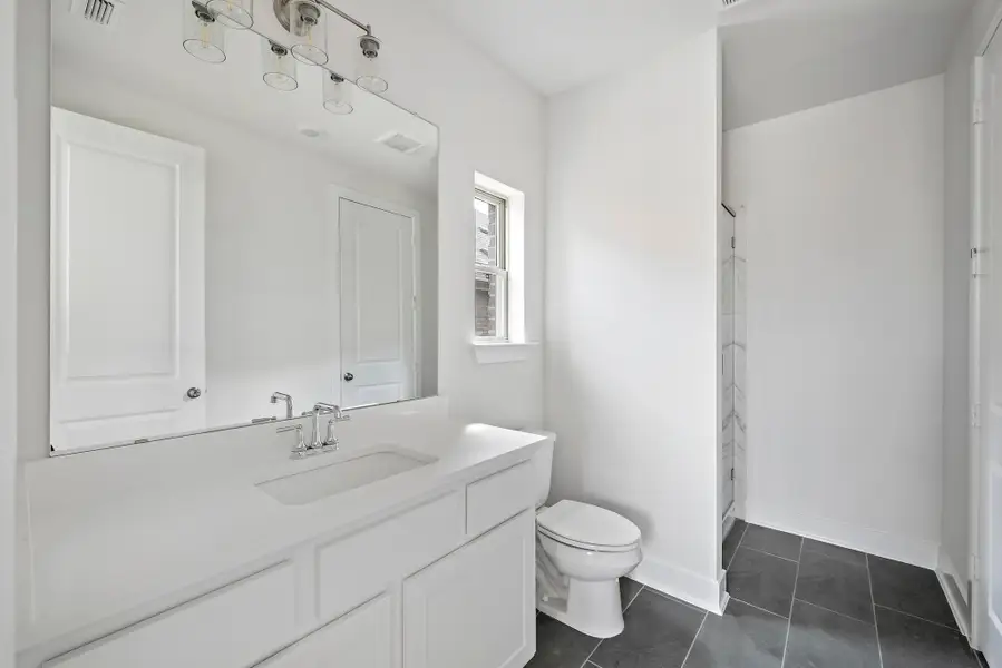 Full bath featuring vanity, tile patterned flooring, toilet, and visible vents