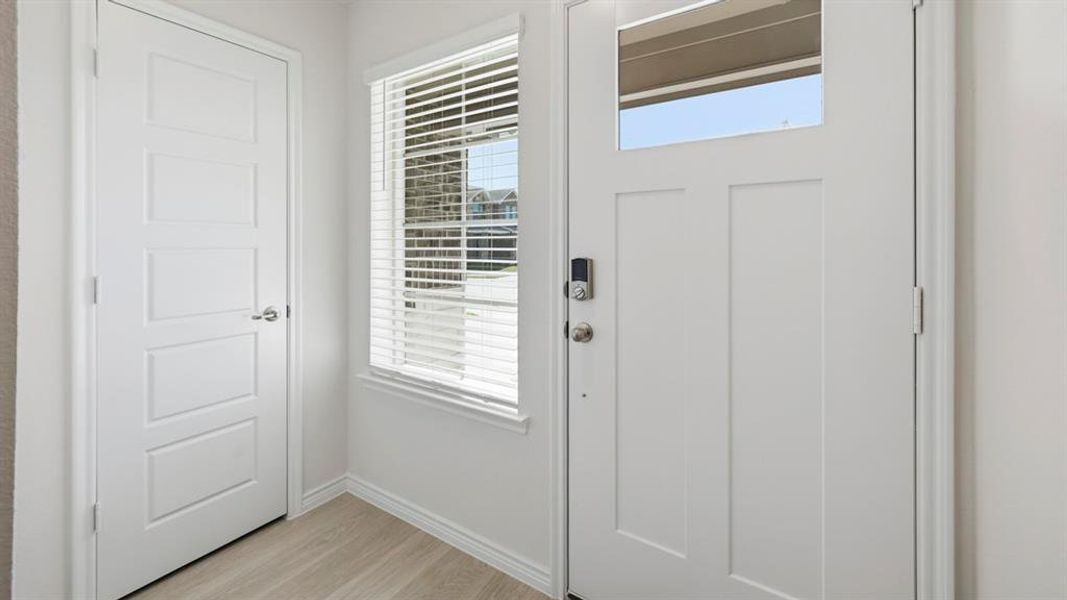 Entrance foyer featuring light wood-style floors and baseboards