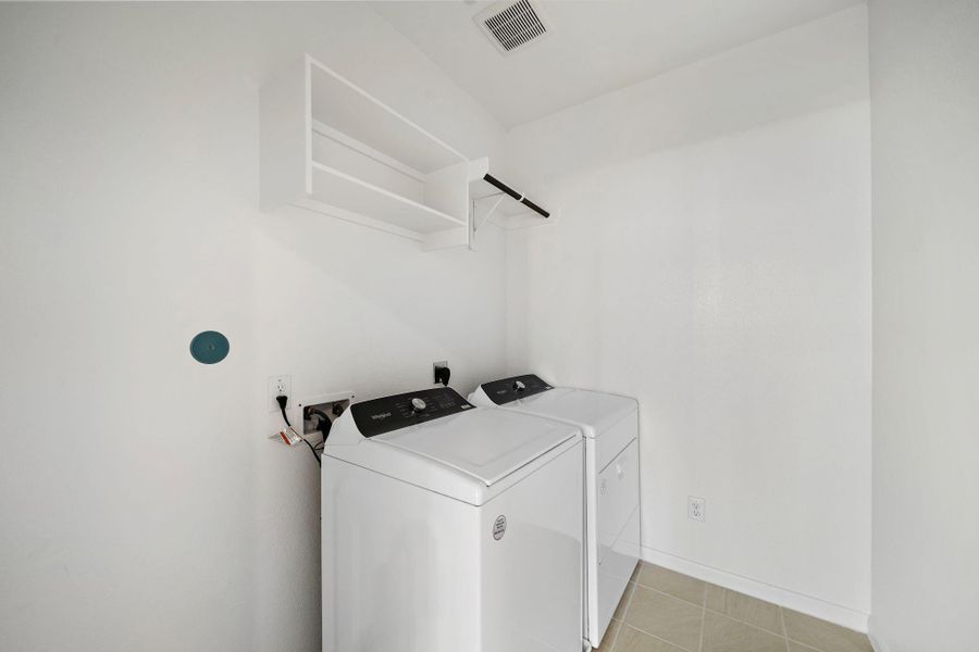 Equipped with a modern washer and dryer, this room provides the convenience of at-home laundry, saving you time and effort.