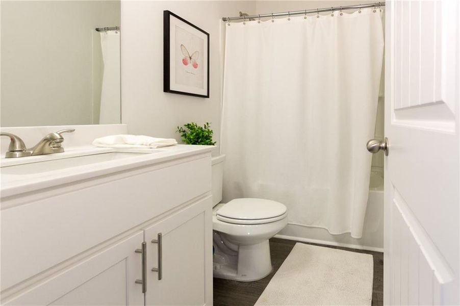 Bathroom featuring toilet, hardwood / wood-style floors, and vanity