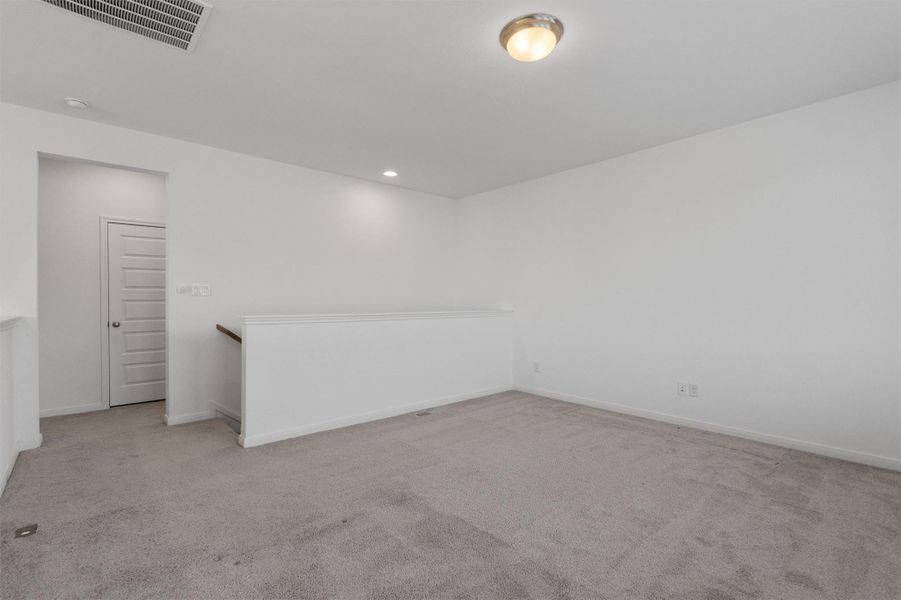 Spare room with light carpet and recessed lighting
