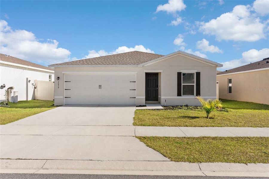 Front exterior of a new home in Sumter Villas, Sumterville, FL, highlighting curb appeal (Image 20).