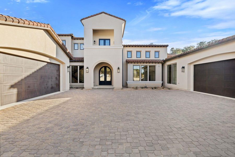 Mediterranean / spanish-style home with french doors, a tile roof, stucco siding, a balcony, and an attached garage