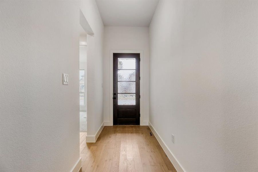 Entryway with light wood-style floors and baseboards