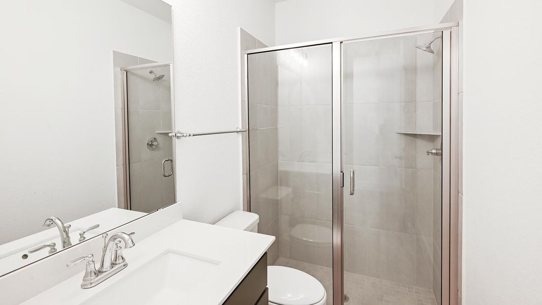 Full bathroom with vanity and a shower stall