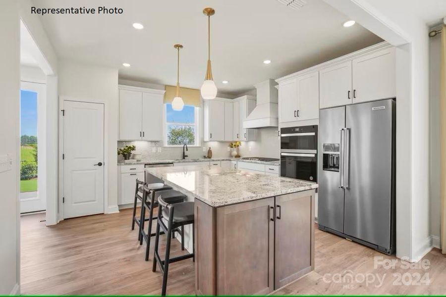 Gourmet kitchen with gas cooktop, large island, and substantial storage