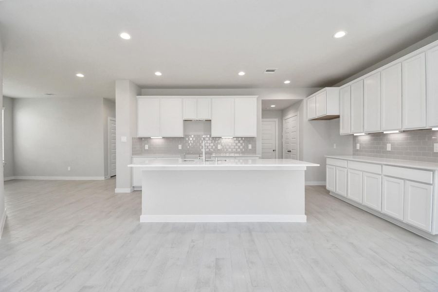 This kitchen is by far any chef’s dream! This spacious kitchen features high ceilings, white stained wood cabinets, granite countertop, SS appliances, modern tile backsplash, recessed lighting, extended counter space, granite kitchen island with double sink, and space for breakfast bar, and a walk-in pantry all overlooking your huge family room. Sample photo of completed home with similar floor plan. Actual colors and selections may vary.