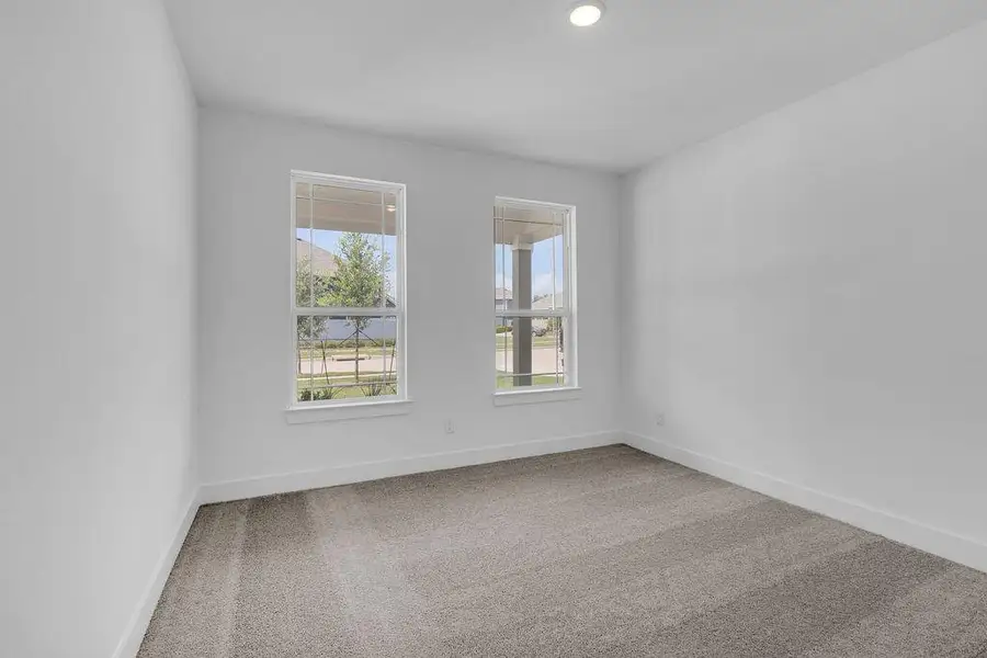 Located downstairs, this secondary bedroom is ideal for a growing family or a visiting parent, with a full bathroom located just outside the bedroom door in the hallway.