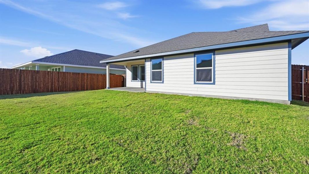 Rear view of property featuring a patio, roof with shingles, and a fenced backyard Rear view of property featuring a patio, roof with shingles, and a fenced backyard