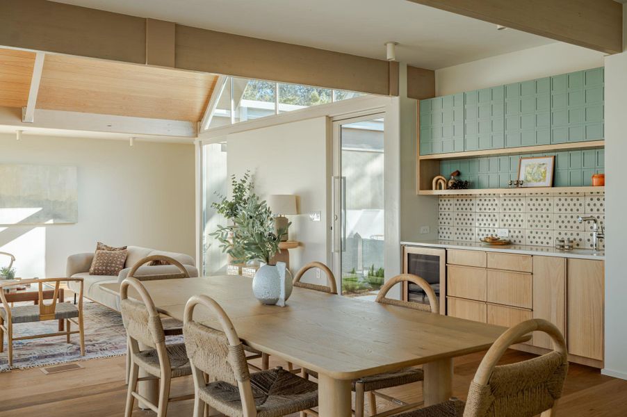 Dining area featuring light wood-type flooring and wine cooler