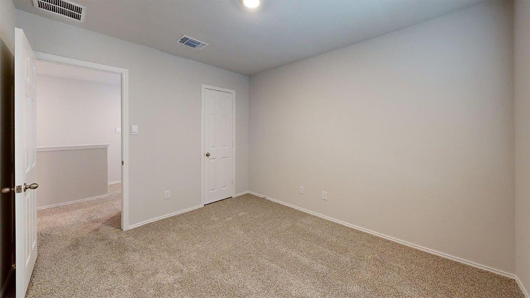 Unfurnished bedroom with light carpet and baseboards Unfurnished bedroom with light carpet and baseboards