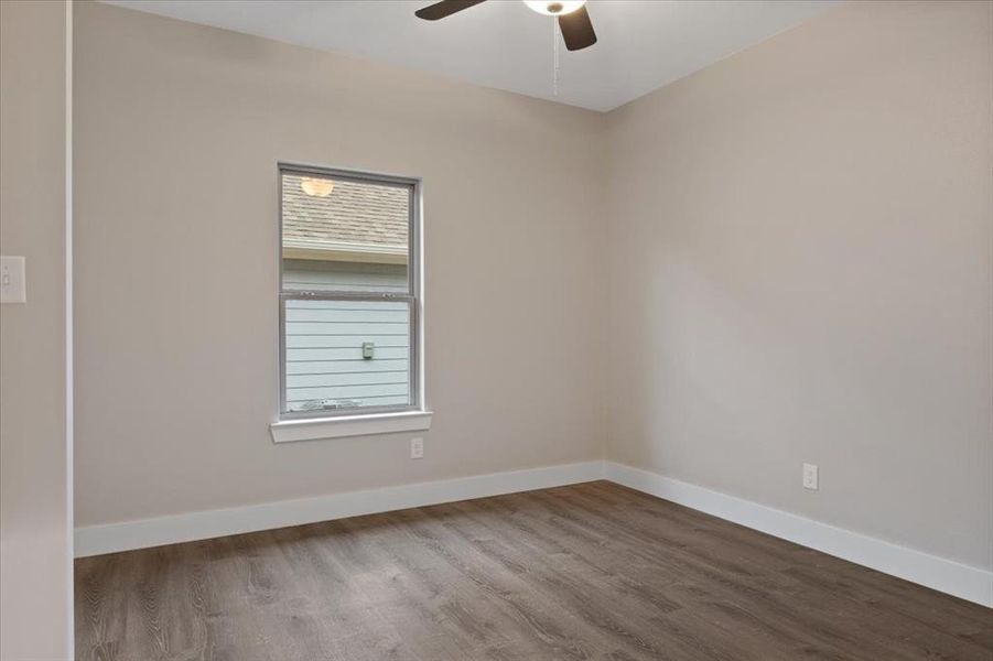 Unfurnished room with wood-type flooring and ceiling fan