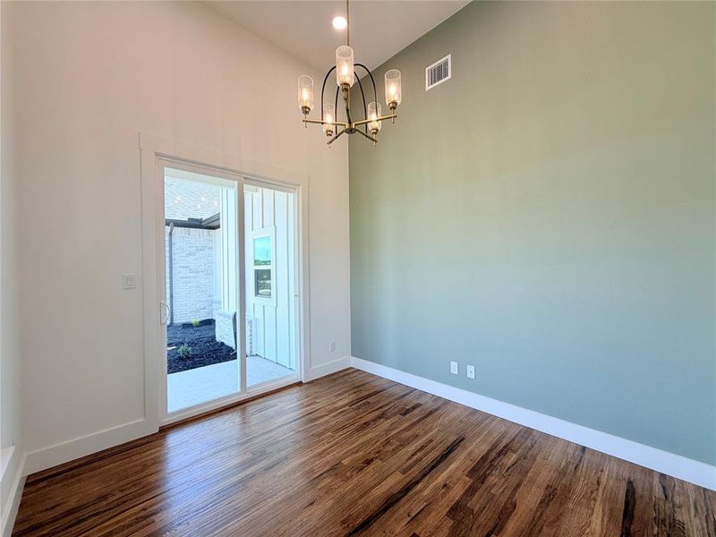 Sliding glass doors from office leading onto the wrapped front porch