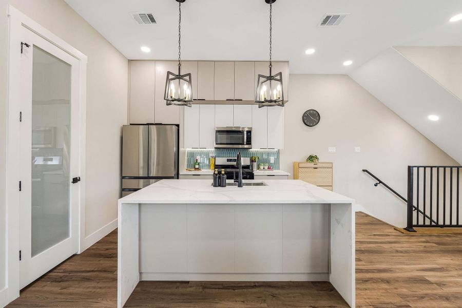Oversized island with bar seating overlooks the main living area, creating the perfect gathering space. Oversized island with bar seating overlooks the main living area, creating the perfect gathering space.
