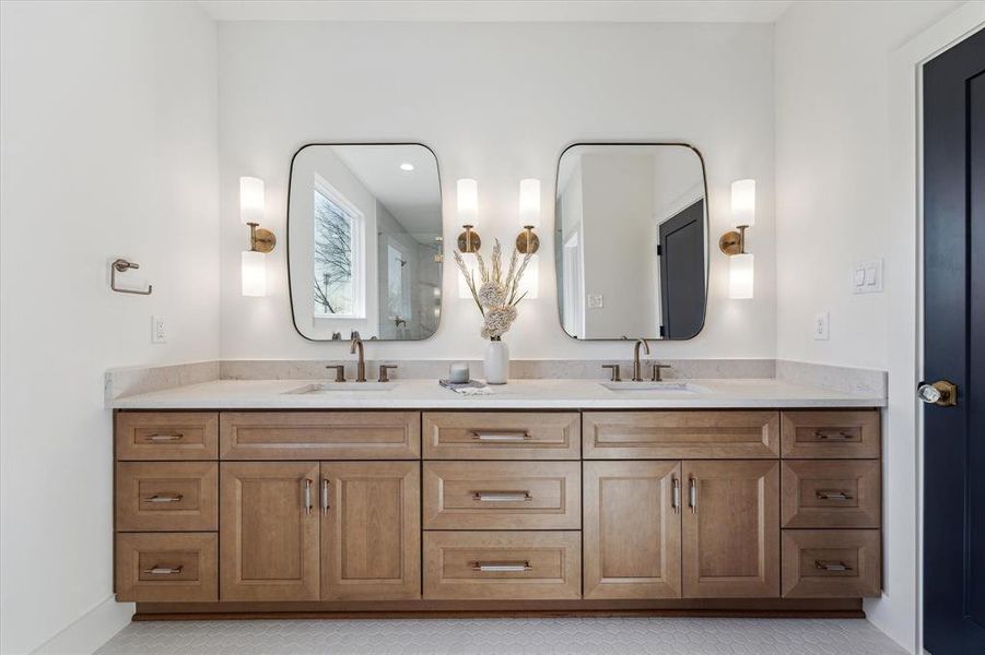 Show stopper primary bathroom featuring double sink vanity.