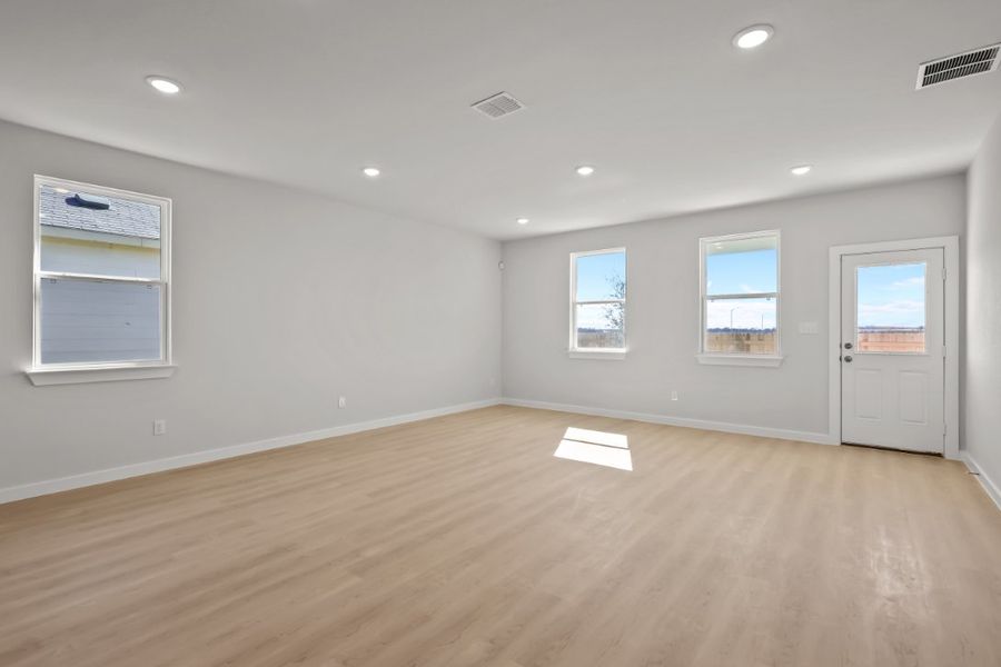 A room with a wood floor and white doors.