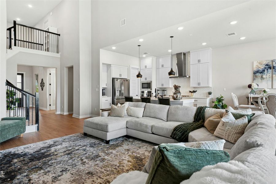 Open Living area with plenty of natural light, a high ceiling, and recessed lighting