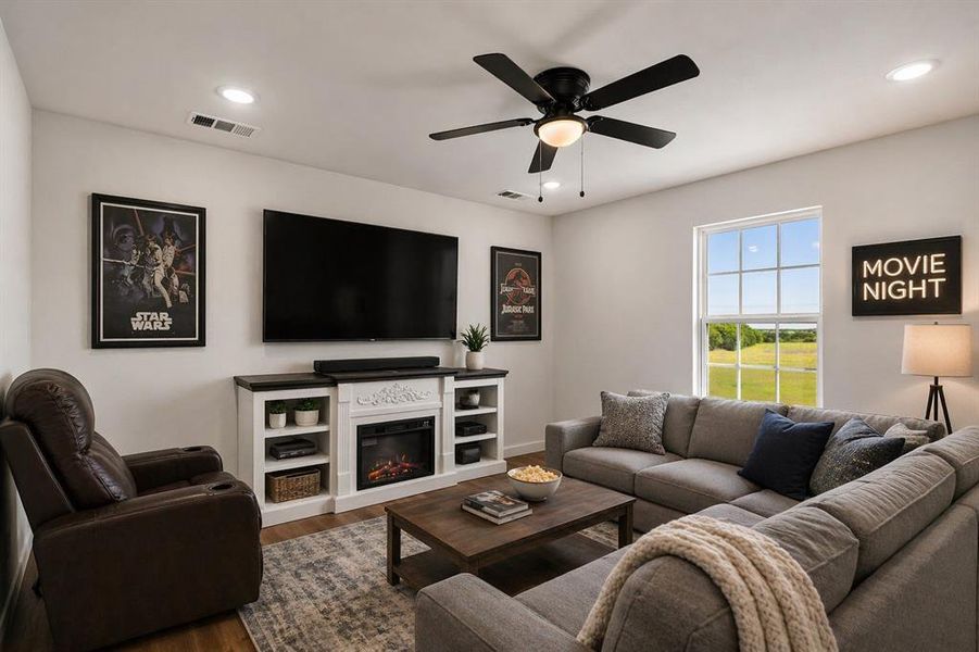 Living area featuring wood-finish flooring, recessed lighting, and a ceiling fan