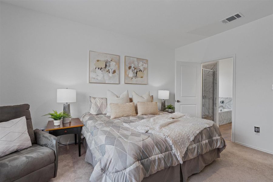 Carpeted bedroom with ensuite bath and baseboards