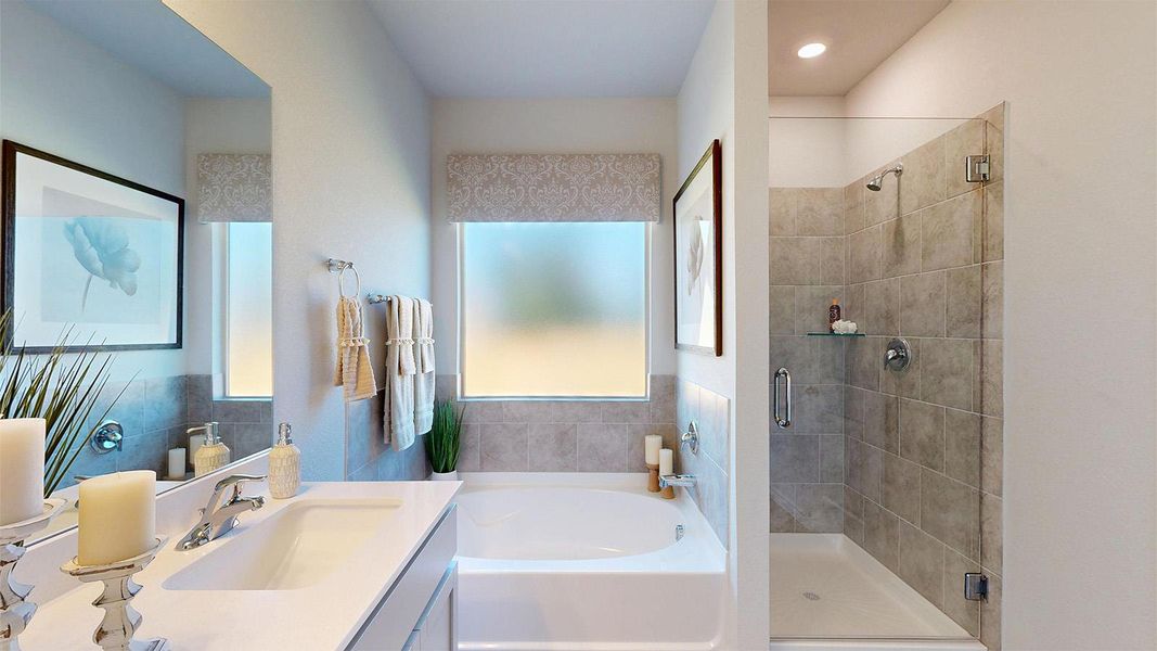 Bathroom featuring vanity, a bath, and a stall shower Bathroom featuring vanity, a bath, and a stall shower