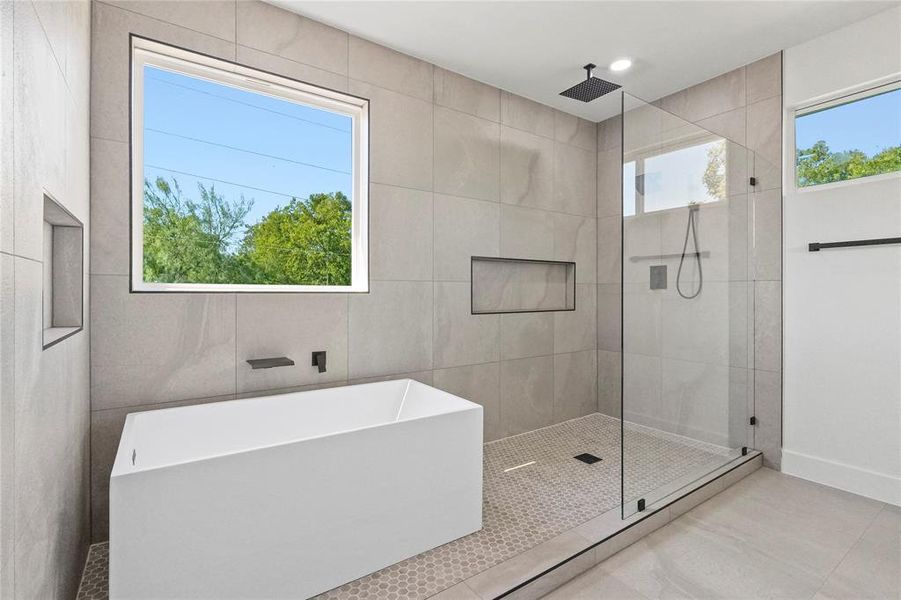 Full bathroom featuring a freestanding tub, a stall shower, and tile patterned flooring Full bathroom featuring a freestanding tub, a stall shower, and tile patterned flooring