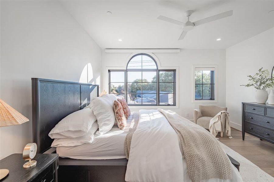 Bedroom featuring wood-type flooring, vaulted ceiling, and ceiling fan